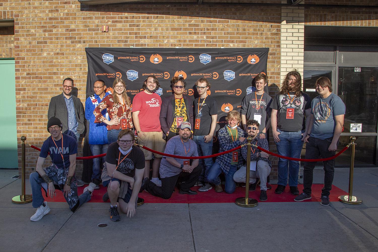 film students stand in front of the theater on the red carpet